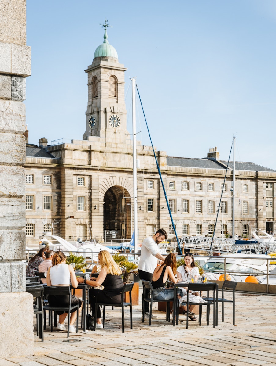 Groups sitting outside prezzo with melville in the background